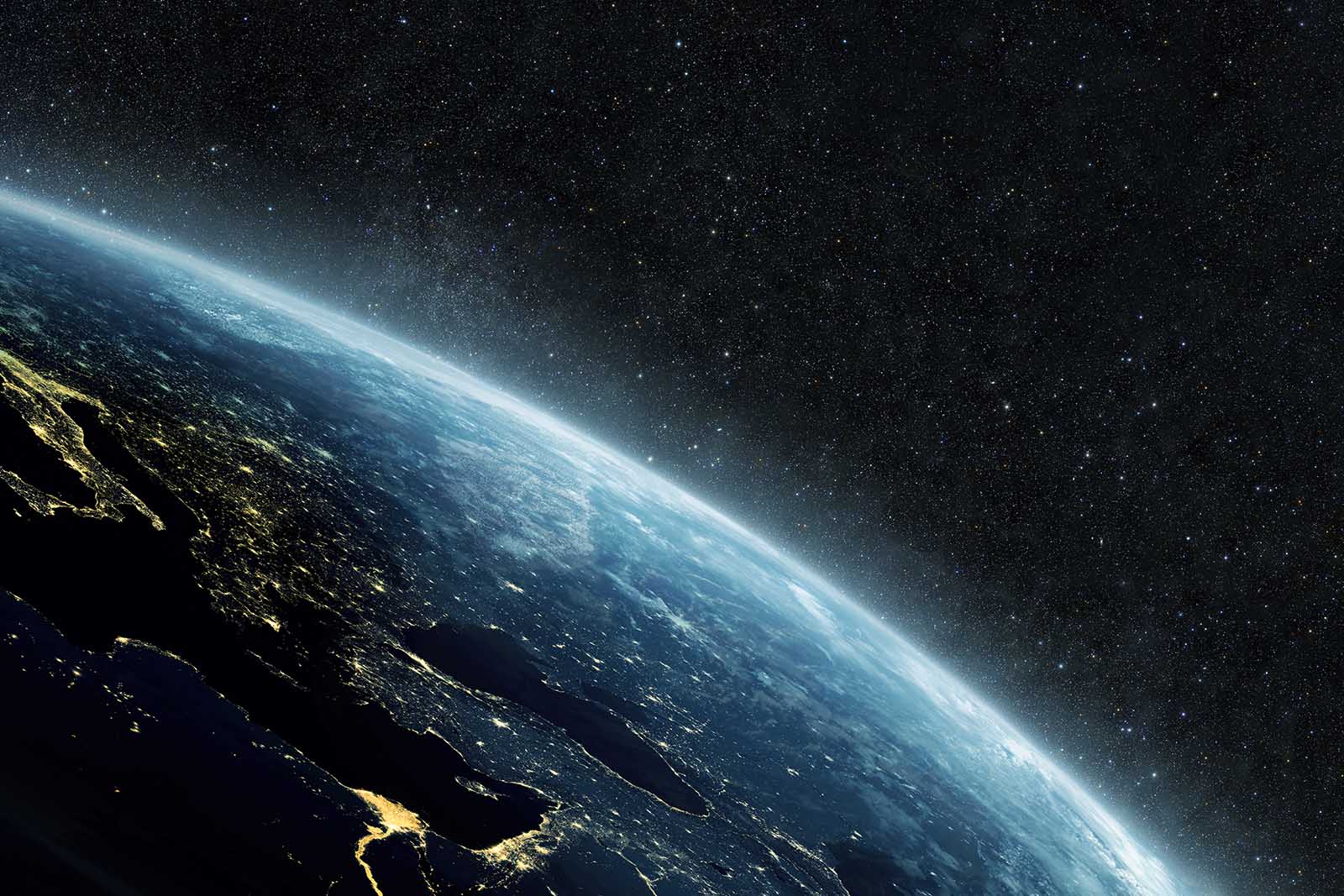 Planet earth with yellow city lights on the starry background in outer space